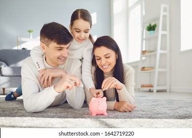 Happy Family Saves Money In A Piggy Bank Pig.