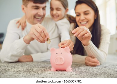 Happy Family Saves Money In A Piggy Bank Pig.