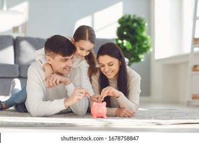 Happy family saves money in a piggy bank pig. - Shutterstock ID 1678758847