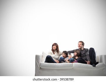 happy family seated on a couch with copy space - Powered by Shutterstock