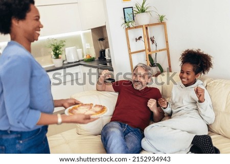 Happy family sharing pizza together at home