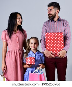 happy family with shopping bags. sale, consumerism and people concept. parents and their daughter are holding paper bags. shopper team of relatives. shopping weekend. holidays - Shutterstock ID 1935255986