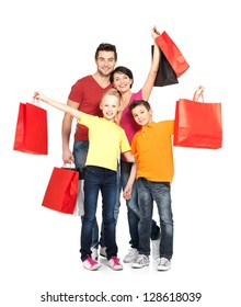 Happy Family With Shopping Bags Standing At Studio Over White Background