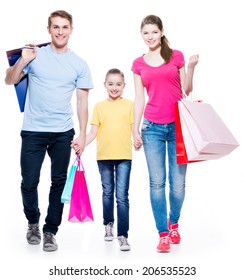 Happy Family With Shopping Bags Standing At Studio Over White Background.