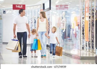 A Happy Family Is Shopping In A Store