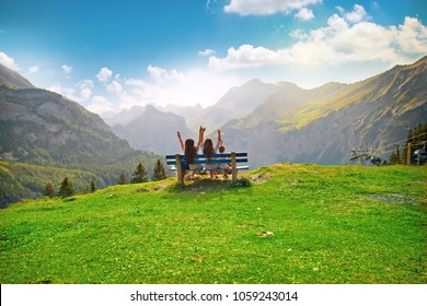 happy family sitting on a bench in nature and looking at the environment, landscape, mountains, forests, sky, joyful people travel and admire the panorama - Shutterstock ID 1059243014