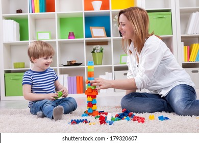 Happy family sitting on the floor and playing with toys - Shutterstock ID 179320607