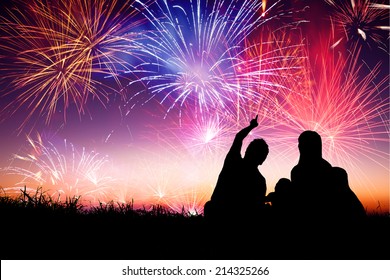 Happy Family Sitting On Floor And Watching The Fireworks