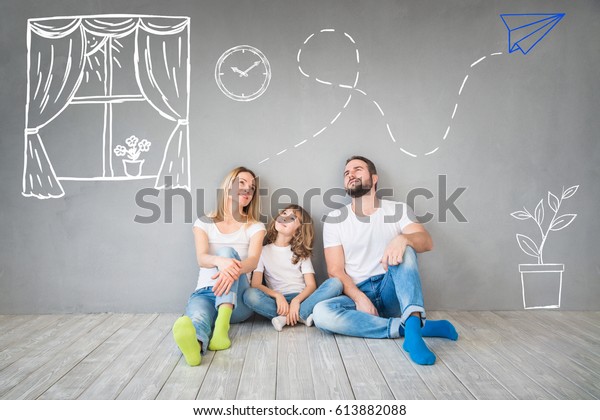 Happy Family Sitting On Wooden Floor Stock Photo Edit Now 613882088