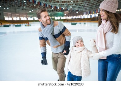 Happy Family At Skating Rink