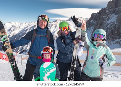 Happy Family Skiing At The Mountains. Kids In Ski School. Winter Sport For Your Kid. Family Christmas Vacation In The Alps. Children Learn Downhill Snowboarding. Alpine Ski Lesson For Boy And Girl