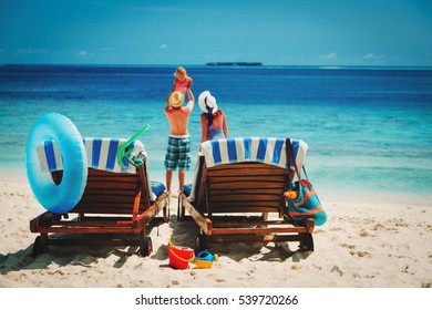 Happy Family With Small Child On Tropical Beach