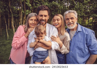 Happy family smiling and looking joyful on the nature background - Powered by Shutterstock