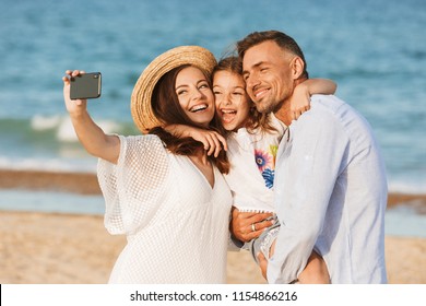 Happy Family Spending Good Time At The Beach Together, Taking Selfie