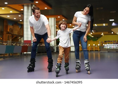 Happy Family Spending Time At Roller Skating Rink