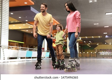 Happy Family Spending Time At Roller Skating Rink