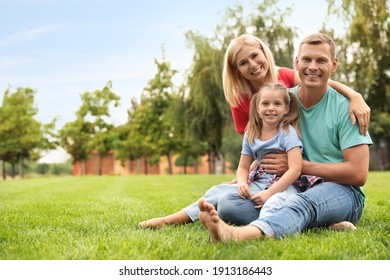 Happy family spending time together in park on sunny summer day