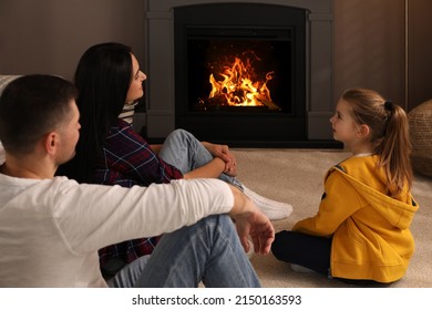 Happy Family Spending Time Together Near Fireplace At Home