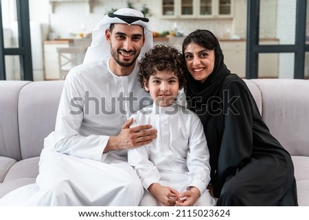 happy family spending time together. Arabian parents and their son playing and making different activities at home
