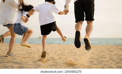 Happy family spending vacation time together on beach - Shutterstock ID 2343581275