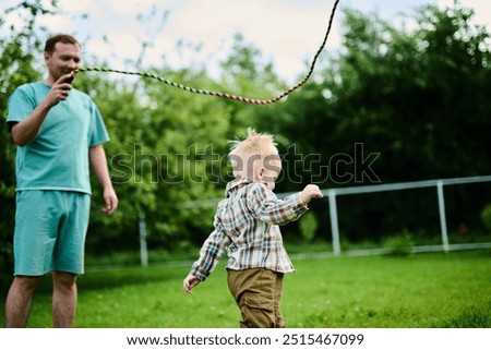 Similar – junge wirft einen Ball auf die Oma