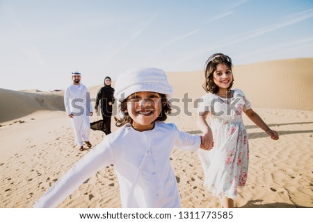 Happy family spending a wonderful day in the desert making a picnic