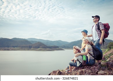 Happy Family Standing Near The Lake At The Day Time.  Concept Of Friendly Family.