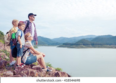 Happy Family Standing Near The Lake At The Day Time.  Concept Of Friendly Family.