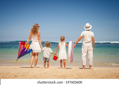 Happy Family Standing On The Beach At The Day Time