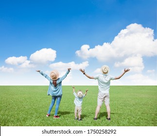 Happy  Family Standing On The Grass And Watching  Cloud  Background