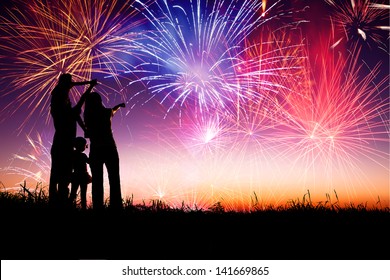 Happy Family Standing On The Hill And Watching The Fireworks