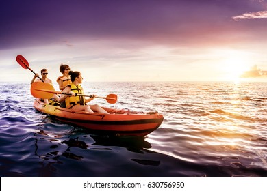 Happy Family Swimming By Kayak At Sunset Sea