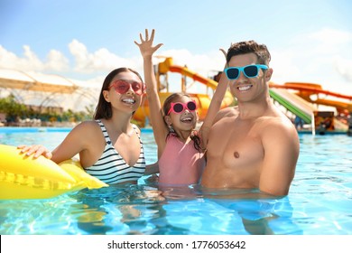 Happy Family In Swimming Pool. Summer Vacation