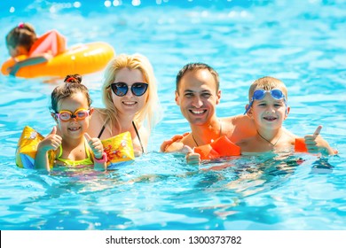 Happy Family In Swimming Pool At Water Park