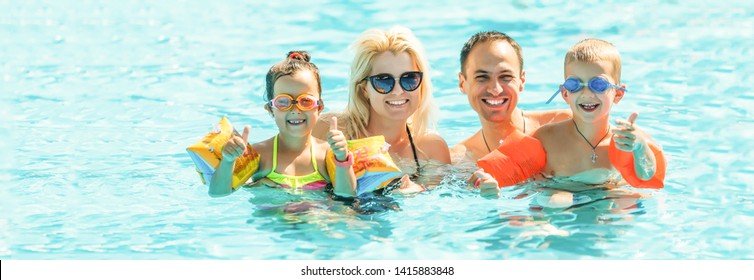 Happy Family In Swimming Pool At Water Park