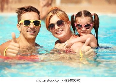 Happy Family In Swimming Pool At Water Park