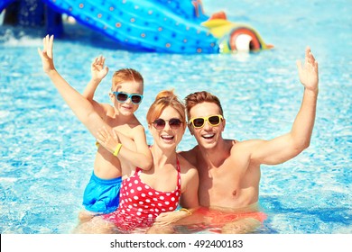 Happy Family In Swimming Pool At Water Park