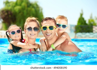 Happy Family In Swimming Pool At Water Park