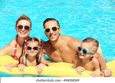 Happy Family In Swimming Pool At Water Park