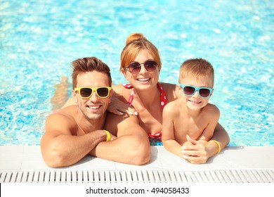 Happy Family In Swimming Pool At Water Park