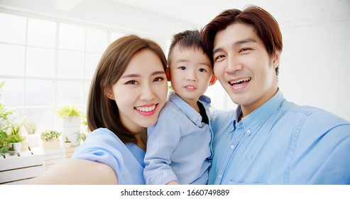 happy family take a selfie by smart phone at home - Powered by Shutterstock