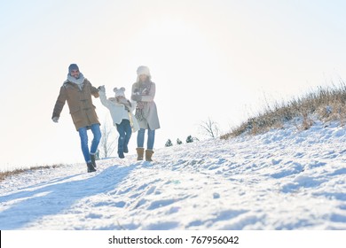 Happy Family Takes A Walk In The Snow In Winter