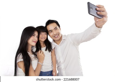 Happy Family Taking Picture Together In Studio, Isolated Over White Background