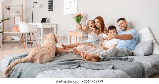 Happy family taking selfie in bedroom at home - Powered by Shutterstock