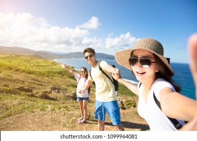 happy family taking selfie on the coast - Powered by Shutterstock