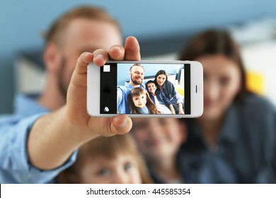 Happy Family Taking Selfie On Blue Wall Background