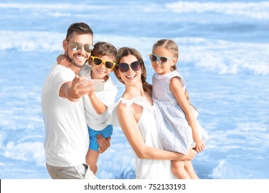 Happy Family Taking Selfie On Sea Beach At Resort