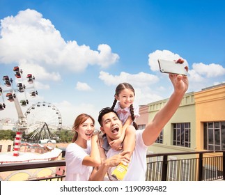 Happy Family Taking Selfie In The Park