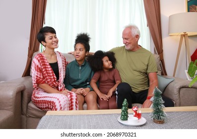 Happy Family Talk Together On Sofa In Living Room