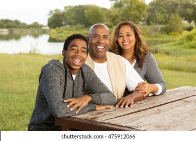 Happy family with teenage child.